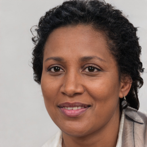 Joyful latino adult female with short  brown hair and brown eyes