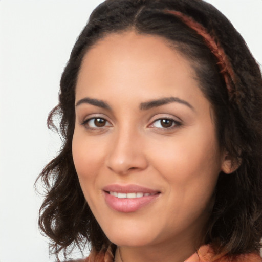 Joyful latino young-adult female with long  black hair and brown eyes