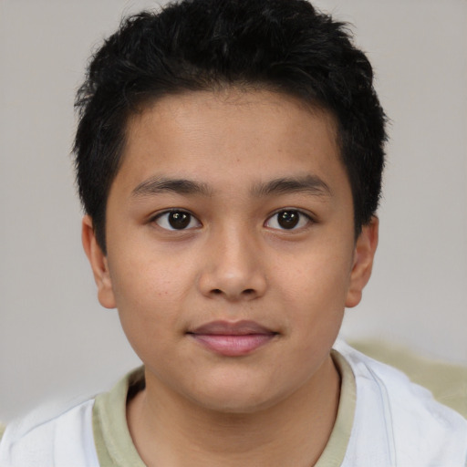 Joyful latino child male with short  brown hair and brown eyes