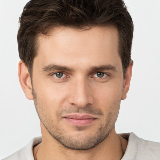 Joyful white young-adult male with short  brown hair and brown eyes