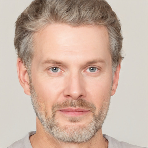 Joyful white adult male with short  brown hair and grey eyes