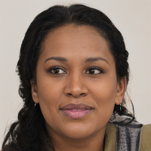 Joyful black young-adult female with medium  brown hair and brown eyes