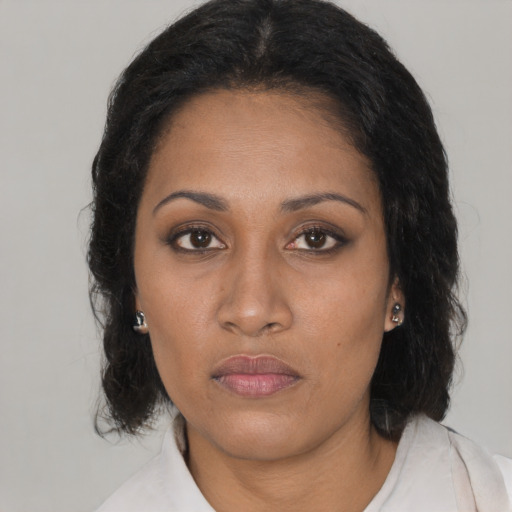 Neutral black young-adult female with medium  brown hair and brown eyes