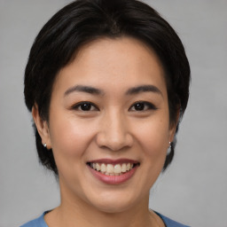 Joyful asian young-adult female with medium  black hair and brown eyes