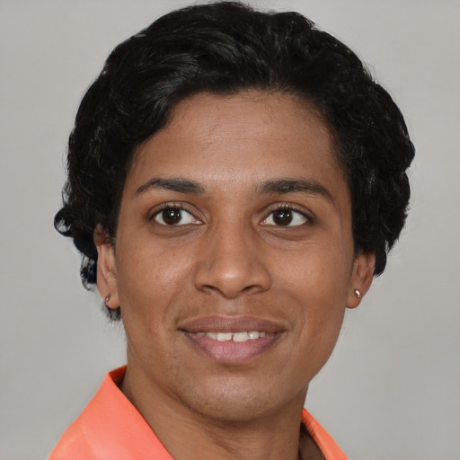 Joyful latino young-adult female with short  black hair and brown eyes