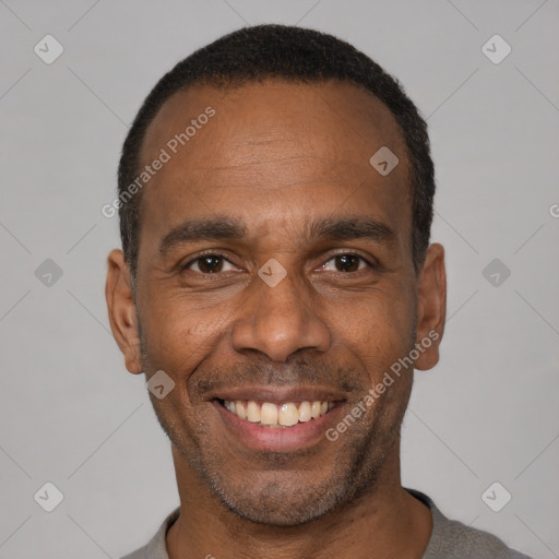 Joyful black adult male with short  black hair and brown eyes