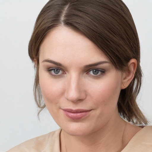 Joyful white young-adult female with medium  brown hair and brown eyes