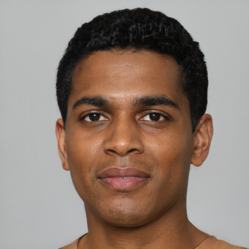 Joyful black young-adult male with short  black hair and brown eyes