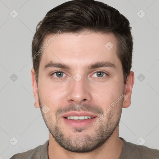 Joyful white young-adult male with short  brown hair and grey eyes