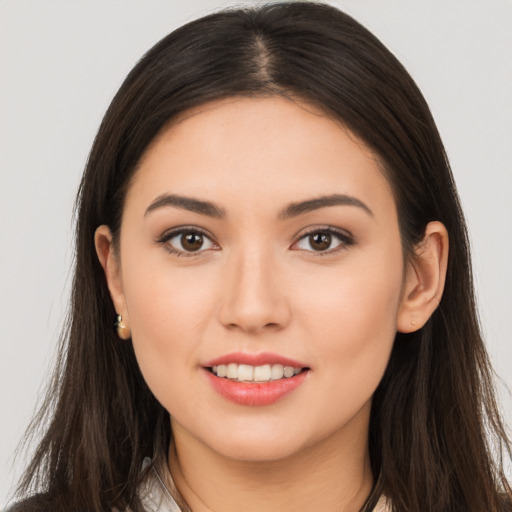 Joyful white young-adult female with long  brown hair and brown eyes