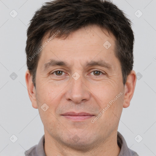 Joyful white adult male with short  brown hair and brown eyes