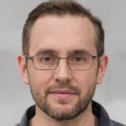 Joyful white adult male with short  brown hair and grey eyes