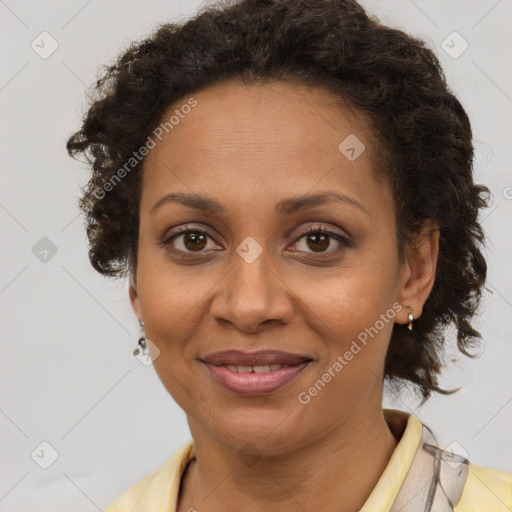 Joyful black adult female with short  brown hair and brown eyes