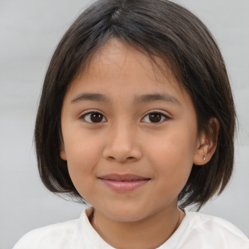 Joyful latino child female with medium  brown hair and brown eyes
