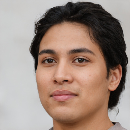 Joyful white young-adult male with medium  black hair and brown eyes