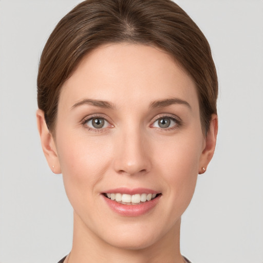 Joyful white young-adult female with short  brown hair and grey eyes