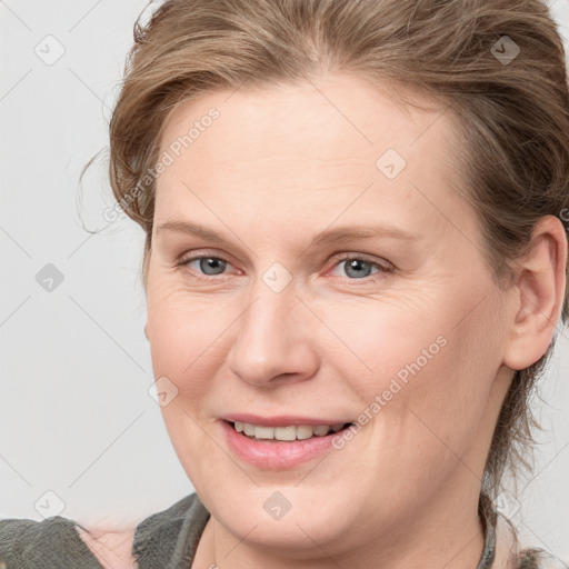 Joyful white young-adult female with medium  brown hair and blue eyes