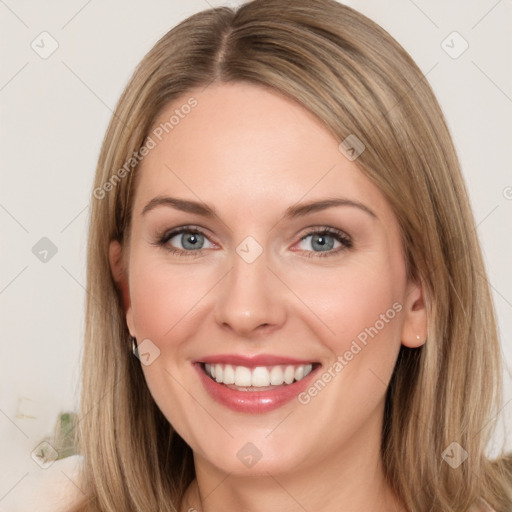 Joyful white young-adult female with long  brown hair and green eyes