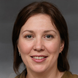 Joyful white adult female with medium  brown hair and grey eyes