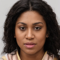 Joyful latino young-adult female with long  brown hair and brown eyes