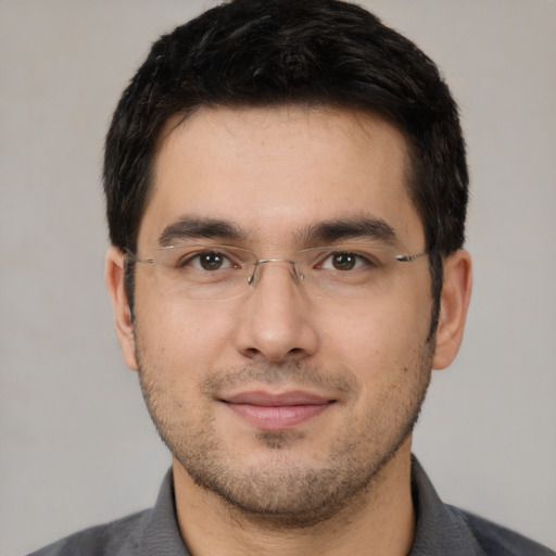 Joyful white young-adult male with short  black hair and brown eyes
