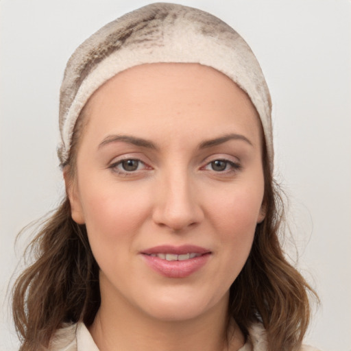 Joyful white young-adult female with medium  brown hair and brown eyes