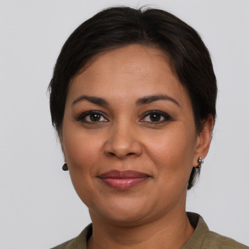 Joyful latino adult female with short  brown hair and brown eyes