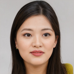 Joyful asian young-adult female with long  brown hair and brown eyes