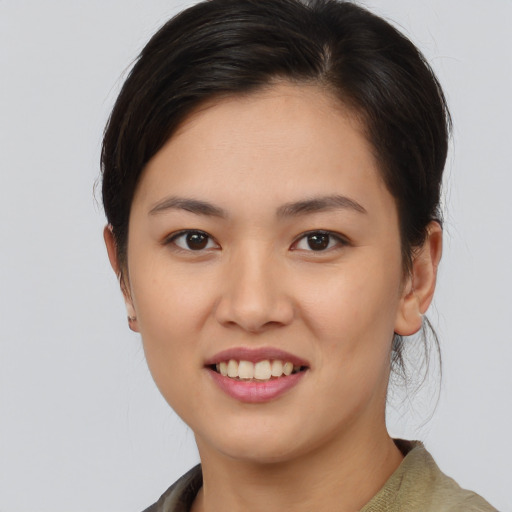 Joyful asian young-adult female with medium  brown hair and brown eyes