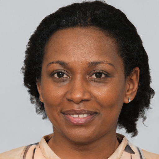 Joyful black adult female with short  brown hair and brown eyes