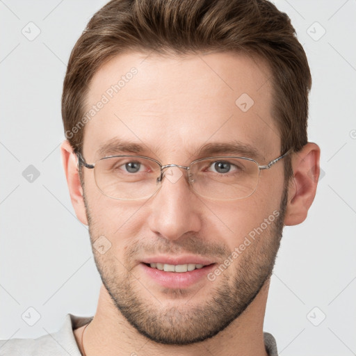 Joyful white young-adult male with short  brown hair and grey eyes