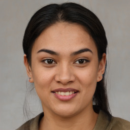 Joyful latino young-adult female with medium  brown hair and brown eyes