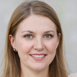 Joyful white young-adult female with long  brown hair and green eyes