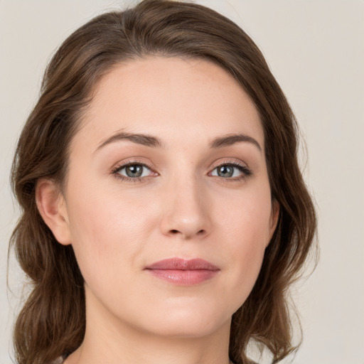 Joyful white young-adult female with medium  brown hair and green eyes