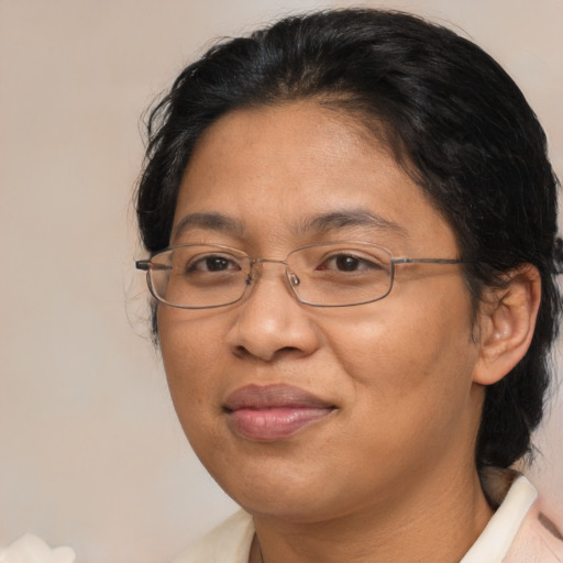 Joyful asian adult female with medium  brown hair and brown eyes