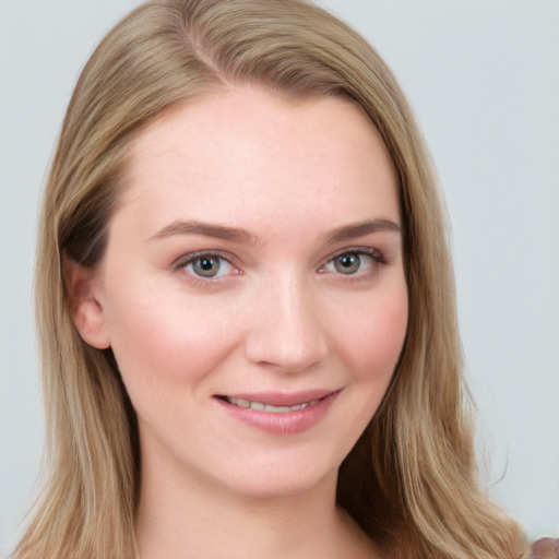 Joyful white young-adult female with long  brown hair and blue eyes