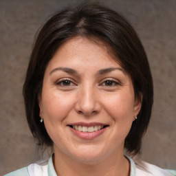 Joyful white adult female with medium  brown hair and brown eyes