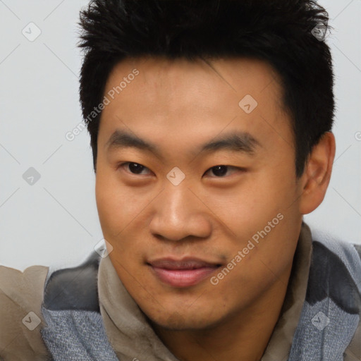 Joyful asian young-adult male with short  black hair and brown eyes