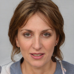 Joyful white adult female with medium  brown hair and grey eyes