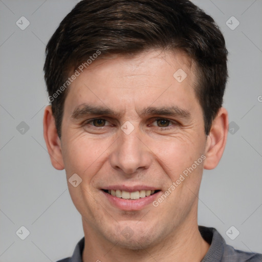 Joyful white adult male with short  brown hair and brown eyes