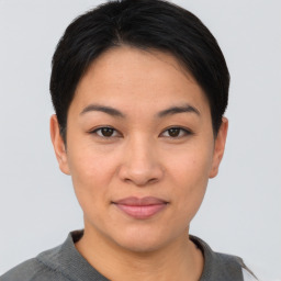 Joyful asian young-adult female with short  brown hair and brown eyes