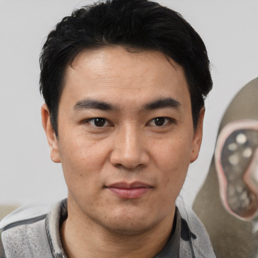 Joyful white adult male with short  black hair and brown eyes