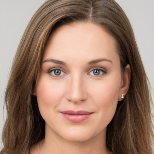 Joyful white young-adult female with long  brown hair and grey eyes