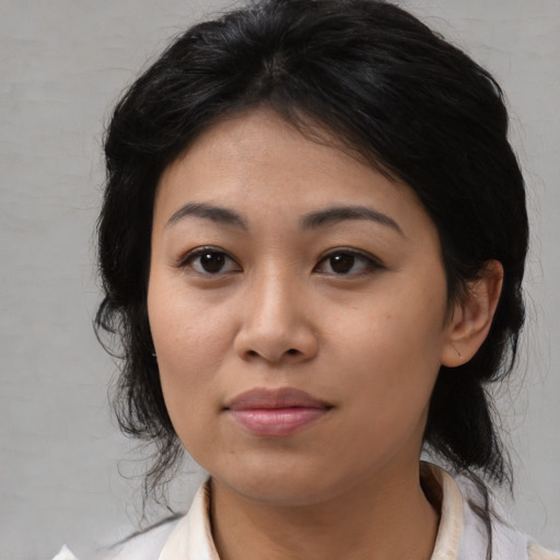 Joyful asian young-adult female with medium  black hair and brown eyes