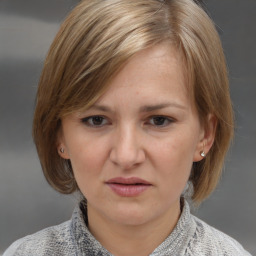 Joyful white young-adult female with medium  brown hair and blue eyes