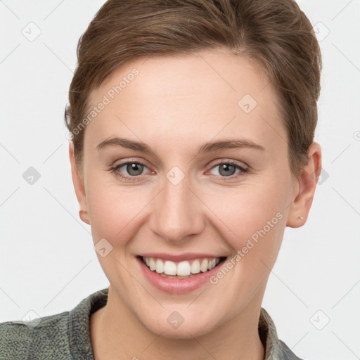 Joyful white young-adult female with short  brown hair and grey eyes