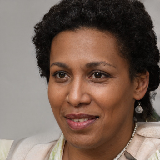 Joyful black adult female with short  brown hair and brown eyes