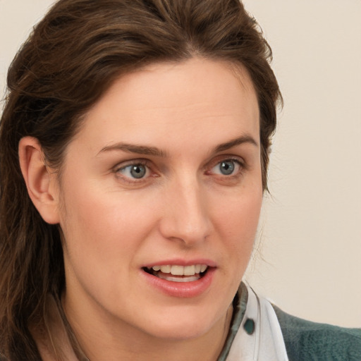 Joyful white young-adult female with medium  brown hair and green eyes