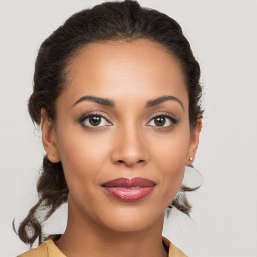 Joyful latino young-adult female with medium  brown hair and brown eyes