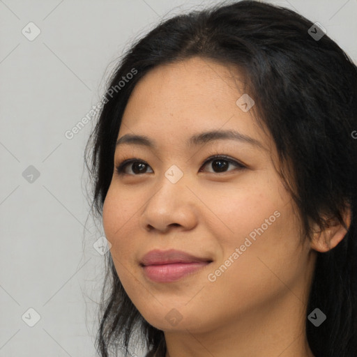 Joyful asian young-adult female with long  brown hair and brown eyes